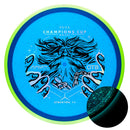 Axiom Particle Glow Proton Hex midrange disc, 2025 Champions Cup "Wizardcraft" stamp, blue disc with green rim