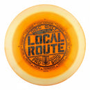 Innova Halo Champion Shryke driver disc, Local Route 2026 Circle the Bay stamp, orange disc with yellow rim